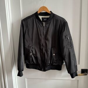 Black satin bomber Jacket with zipper pocket detail at sleeve, quilted interior